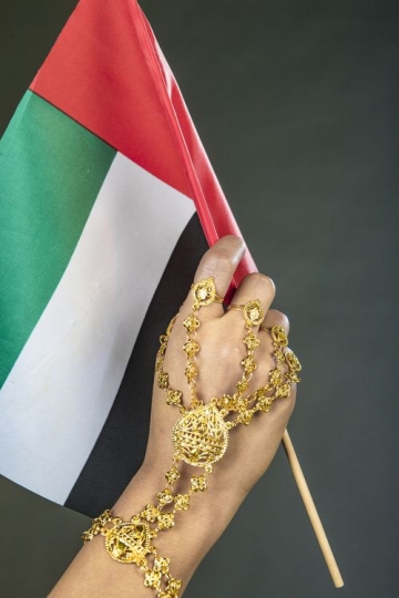 Close up of a Woman carrying a UAE Flag
